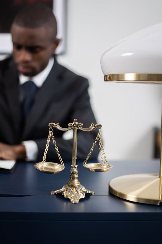 pexels-photo-6077961 Brass Colored Balance Scale on a Lawyer's Table